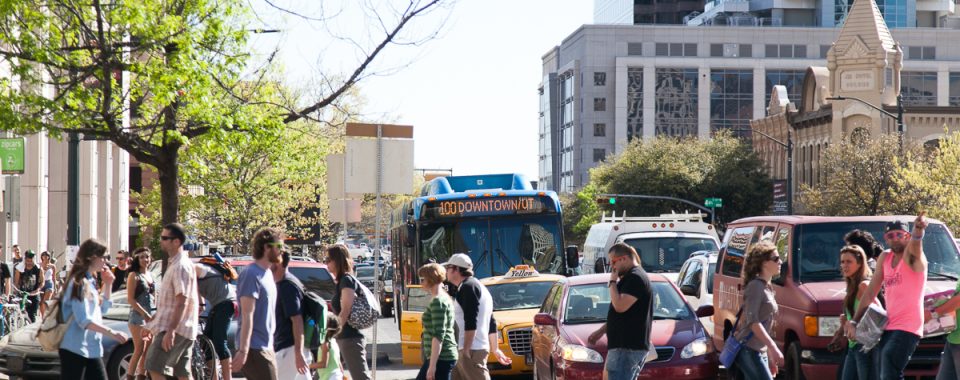 A group of pedestrians crossing a street in downtown Austin